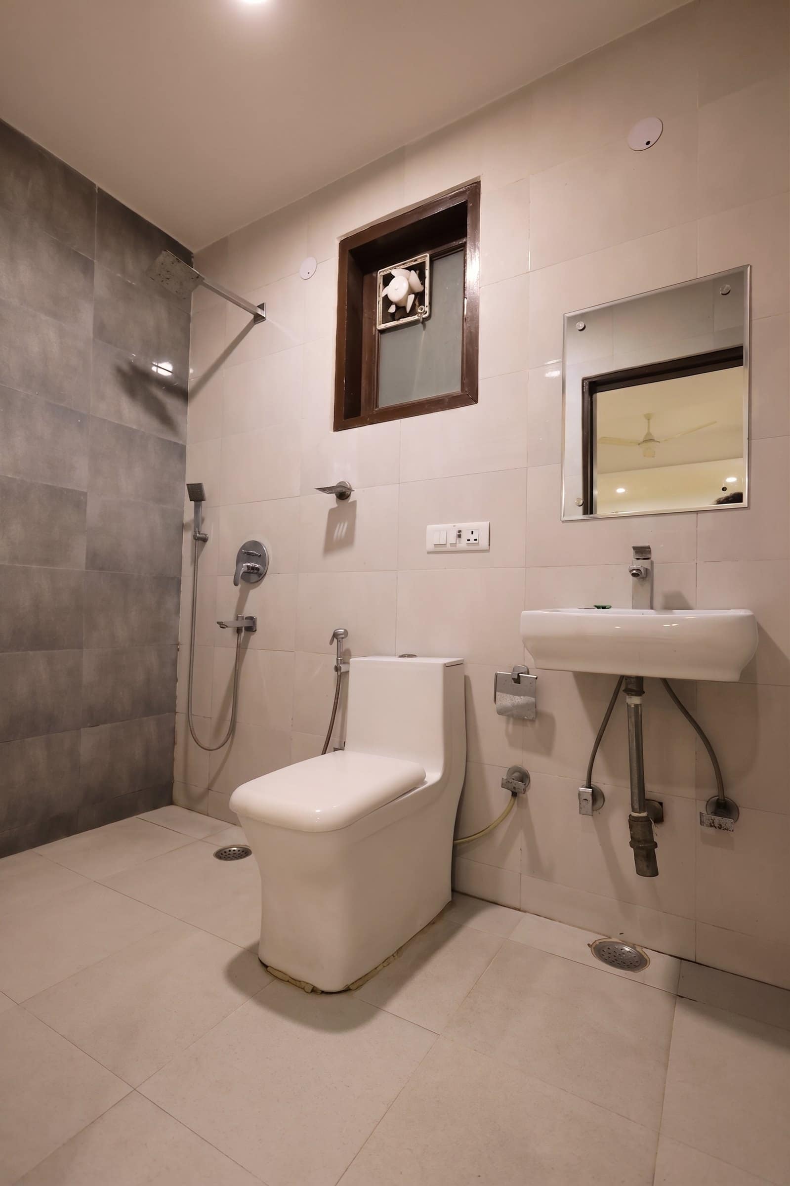 A bathroom finished in dark tile