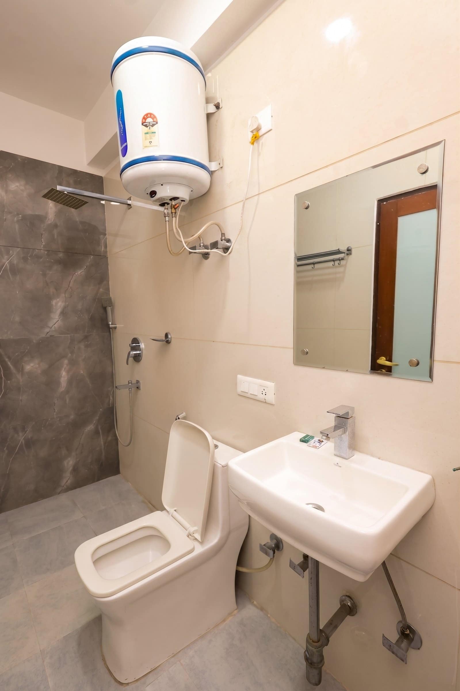 A bathroom with a wall-mounted water heater