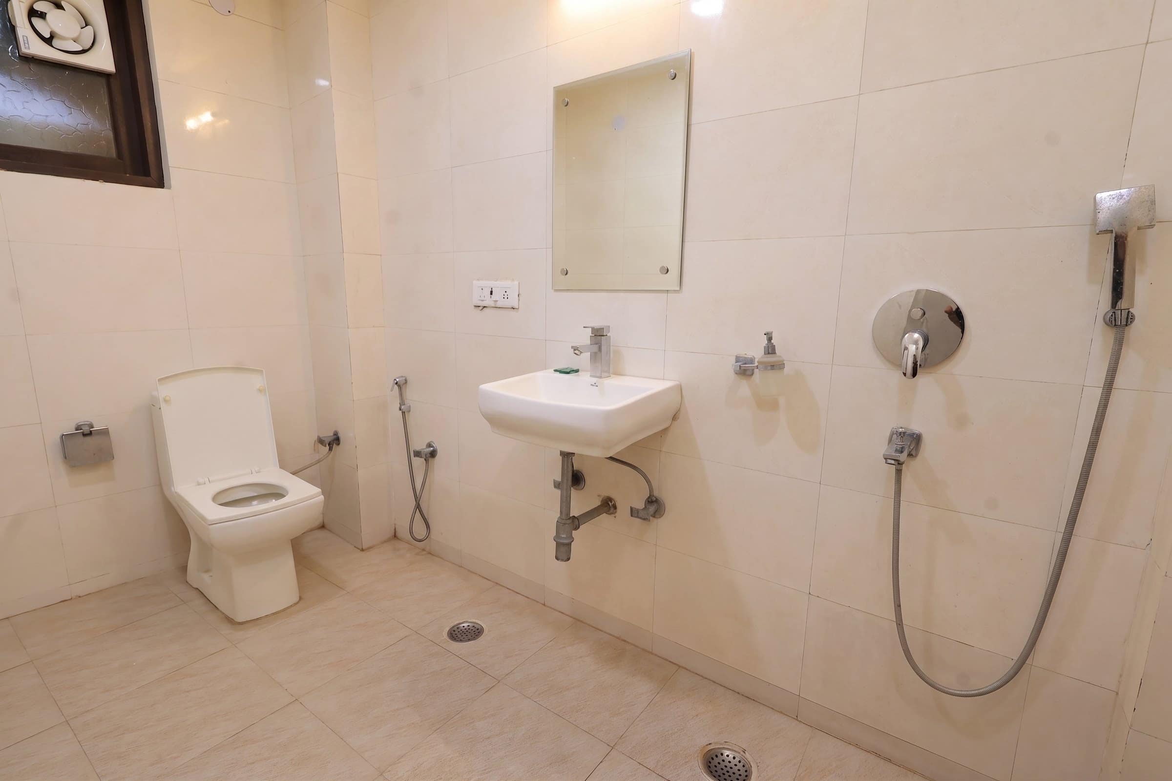 An attached bathroom with a basin and mirror