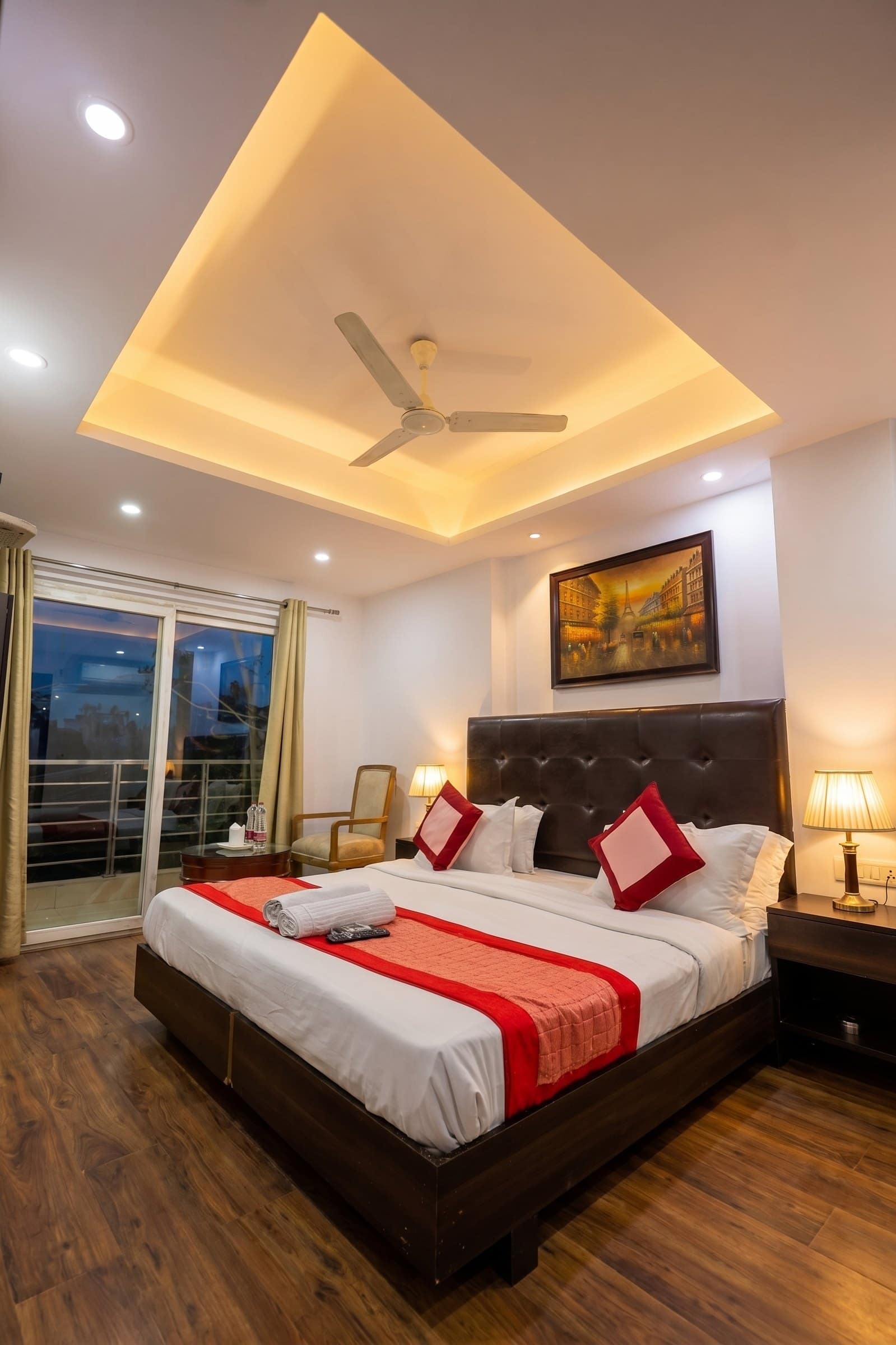 A room at night with the balcony door beyond