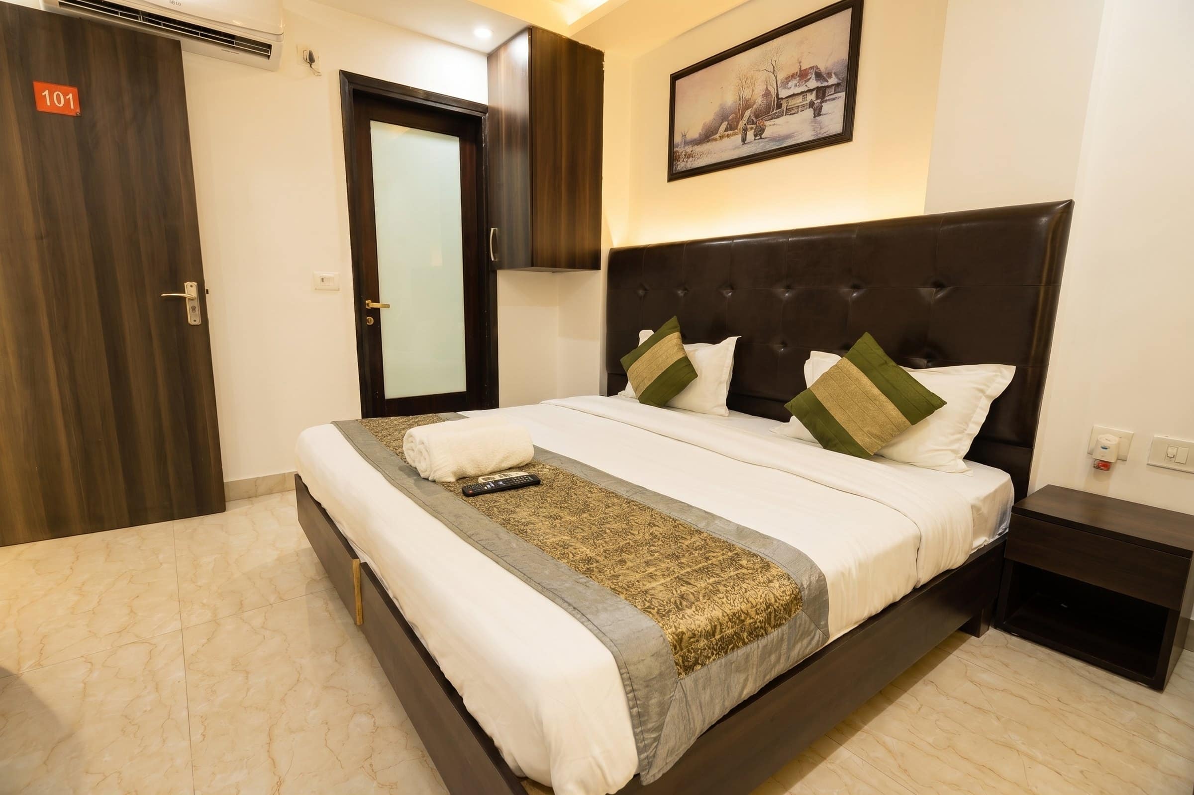 A room with a woven runner across the bed