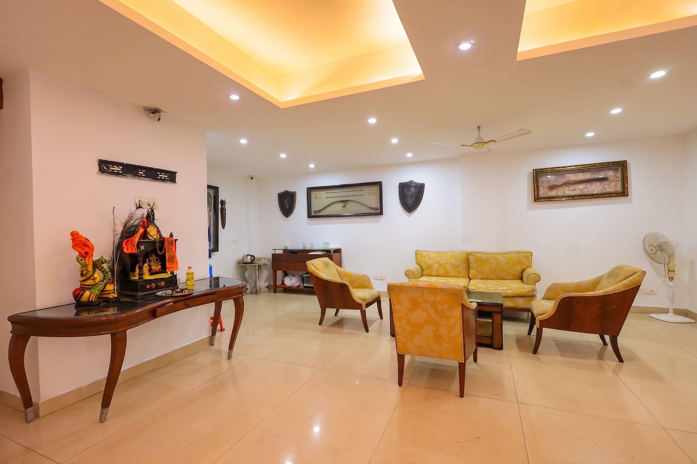 The ground-floor lounge at Taj Home Stay, with sofas and armchairs